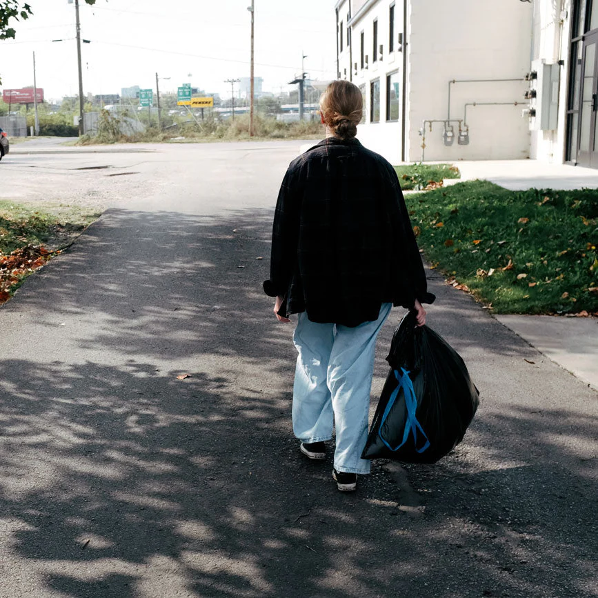 A foster child holding their My Bag My Story bag